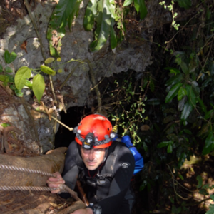 Domnique Rissolo roping up a cliff.